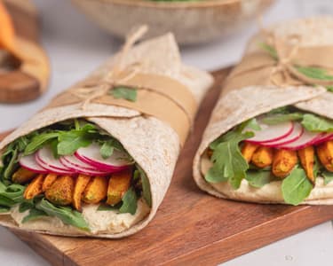 Whole-grain wraps with roasted carrots, hummus, and arugula