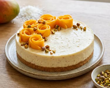 Coconut Cheesecake with Mango and Caramelized Pistachios