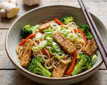 Stir-fry with rice noodles, tempeh, and vegetables