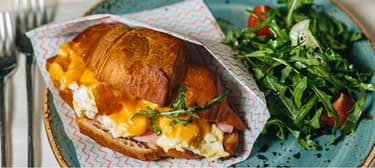 Croissant plněný krémovými míchanými vajíčky a šunkou