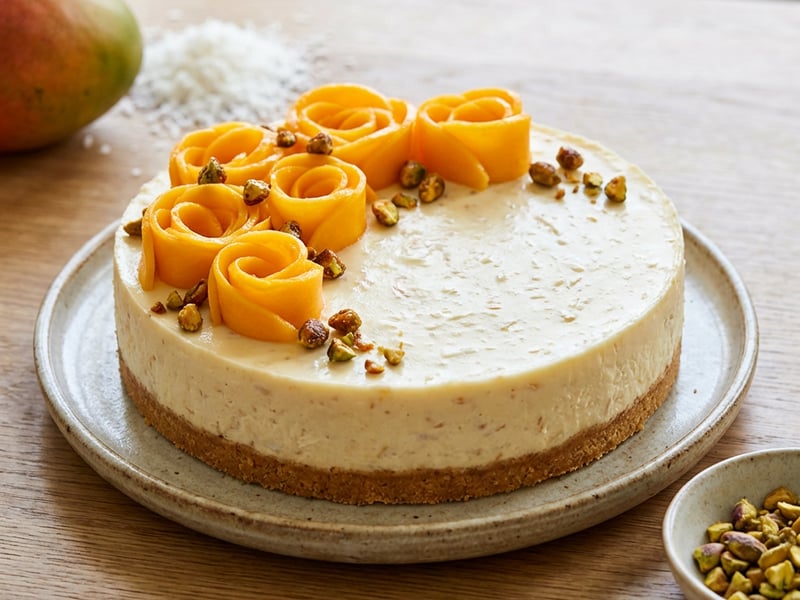 Coconut Cheesecake with Mango and Caramelized Pistachios
