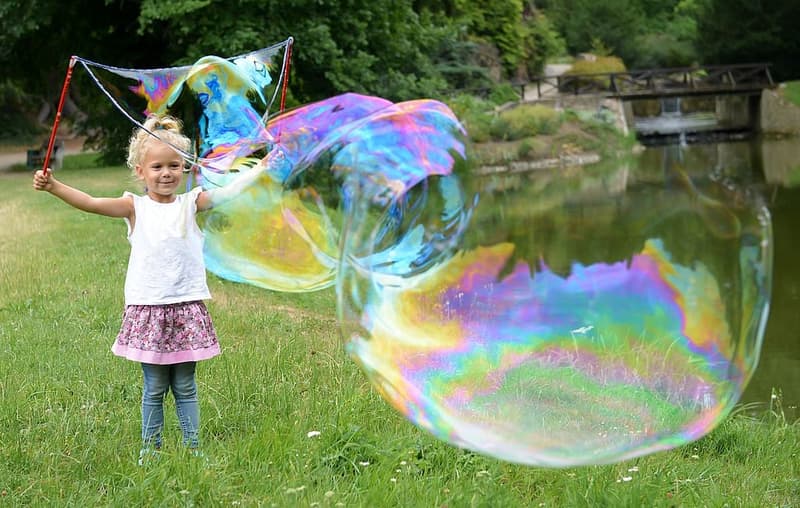 Bubble blower on a giant bubble